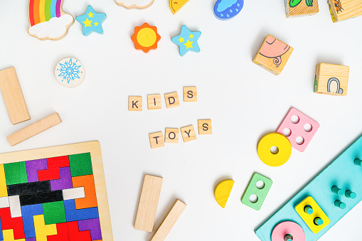 Kids toys. Colorful educational wooden toys on white background. Montessori Games. Child Development. Top view, flat lay