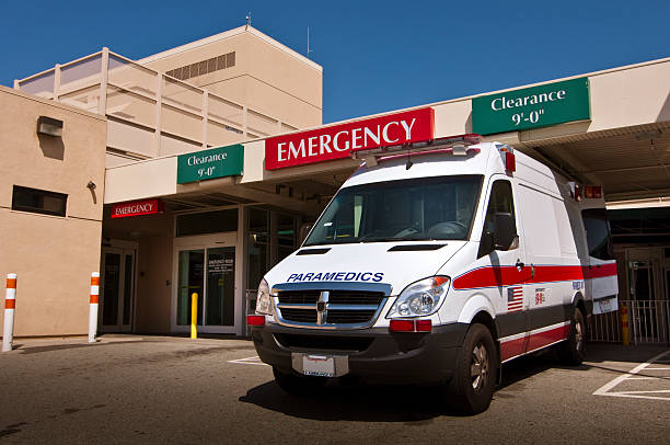Ambulance in front of emergency entrance to hospital stock photo