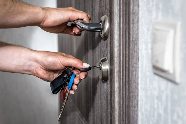Locking up or unlocking entrance door with key in hand stock photo