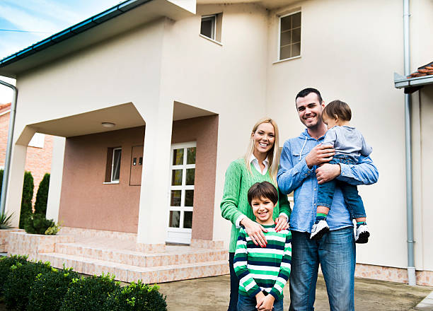 istock Family in front of house 174979201
