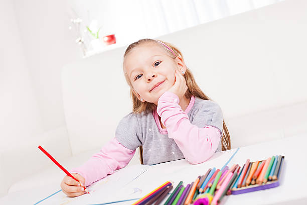 istock Little girl with colored pencils 174979767