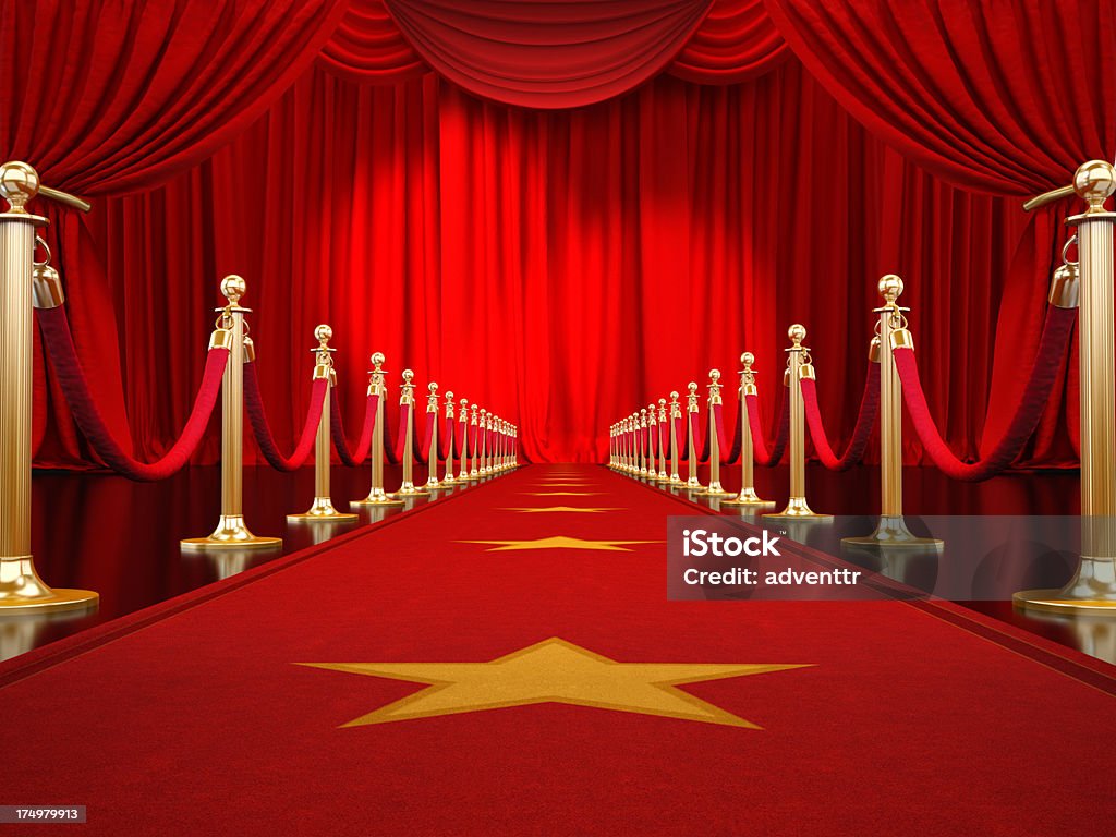 Red carpet to the stage Red carpet with gold stanchions and velvet ropes leading to the stage with red curtains illuminated by spotlights..Similar images: Red Carpet Event Stock Photo