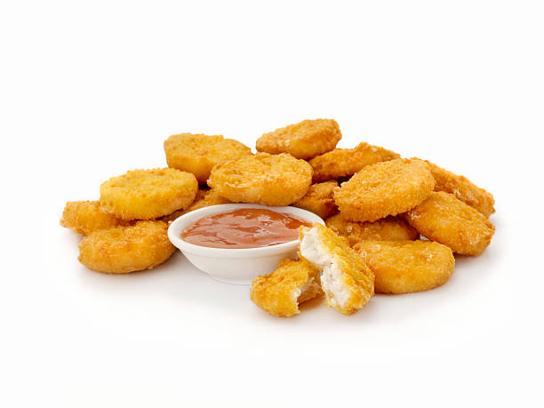 Chicken Nuggets All White Meat Chicken Nuggets with Sweet and Sour Sauce- Photographed on Hasselblad H3D2-39mb Camera nuggets heat stock pictures, royalty-free photos & images