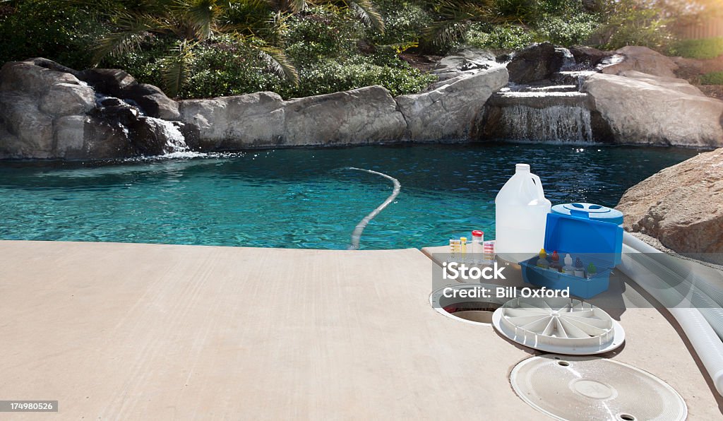 Pool Maintenance Equipment for testing the quality of pool water and cleaning a pool Swimming Pool Stock Photo