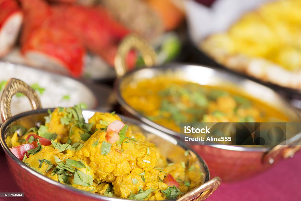 Indian food: assortment including aloo gobi and chicken curry "Indian food: assortment including aloo gobi, chicken curry, basmati rice, chicken tikka masala and naan. You might also be interested in these:" Cauliflower Stock Photo