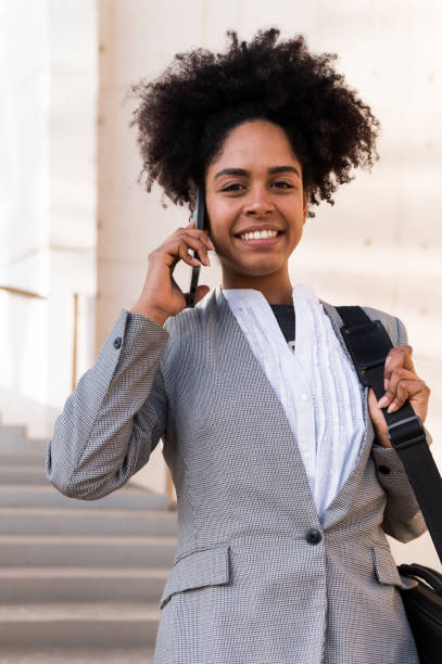 istock African businesswoman looking at camera while talking to the mobile 1749806064