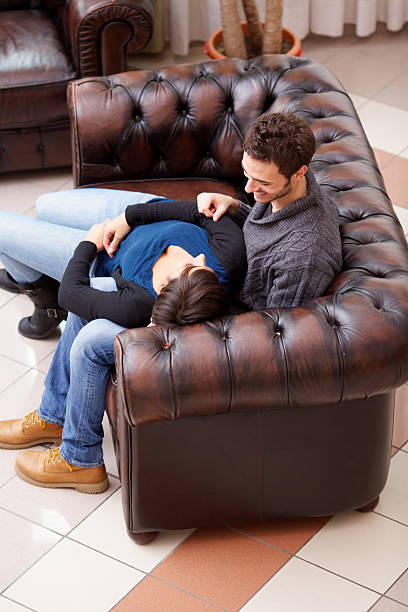 istock Loving young couple on sofa in hotel lobby 174980729