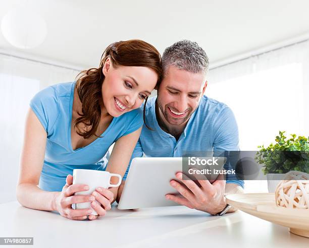 Happy Couple With Digital Tablet Stock Photo - Download Image Now - 25-29 Years, 30-34 Years, Adult