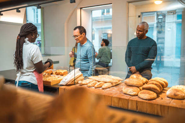 istock Black Female Offering Freshly Baked Bread At An Artisan Bakery 1749808769