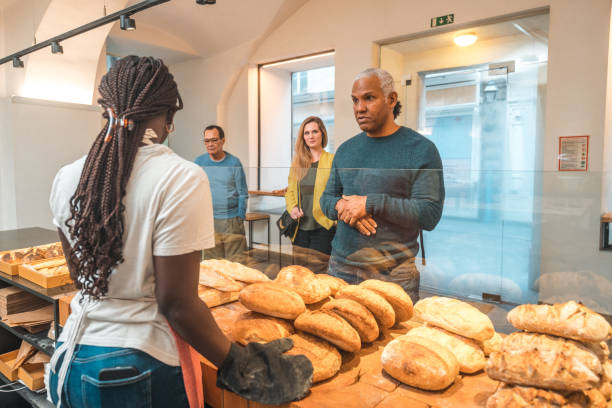 istock Black Female Offering Freshly Baked Bread At An Artisan Bakery 1749809335