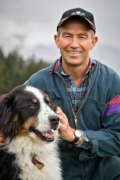 istock Smiling Swiss Farmer With Bernese Mountain Dog 174980961
