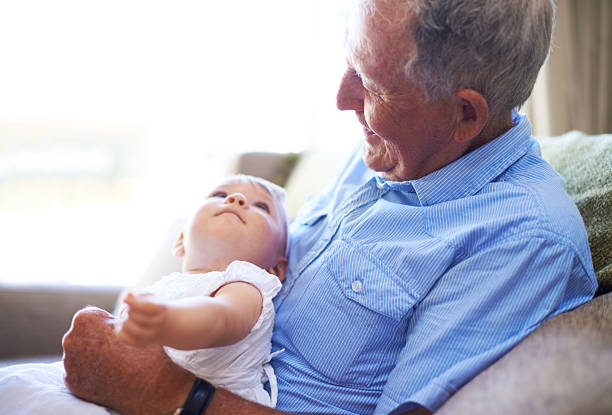 An adorable baby girl spending quality time with her grandfather