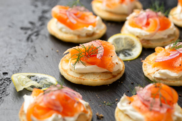 istock Mini blini pancakes with soft cheese, cold smoked salmon and dill 1749817698