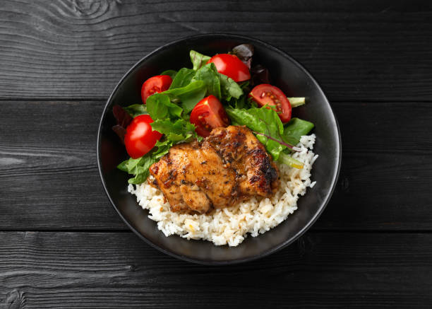 istock Baked balsamic chicken thighs with rice and vegetables 1749820406