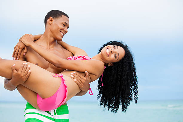 radosny african-american para na plaży - beach couple satisfaction playing zdjęcia i obrazy z banku zdjęć
