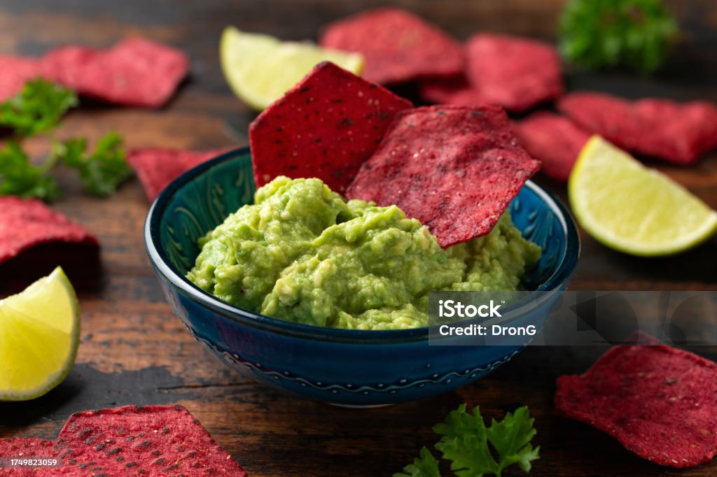 Whole grain beetroot crackers with avocado guacamole dip Whole grain beetroot crackers with avocado guacamole dip. Appetizer Stock Photo