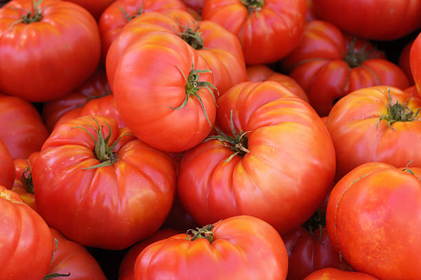 istock Close-up Red Brandywine Tomatoes on Display at Market 174982559