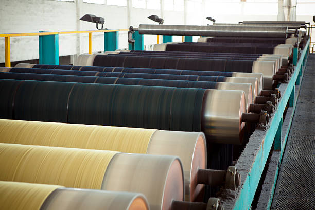 Denim Textile Industry - Rope Dyeing Machine Variation visible as thread color changes in rope dyeing machine for making denim fabric. cotton mill stock pictures, royalty-free photos & images