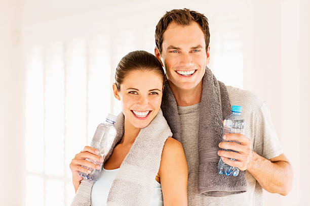 istock Young Couple Holding Water Bottles After Workout 174982755