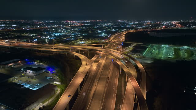 Aerial view of american highway junction at night with fast driving vehicles in Tampa, Florida. View from above of USA transportation infrastructure
