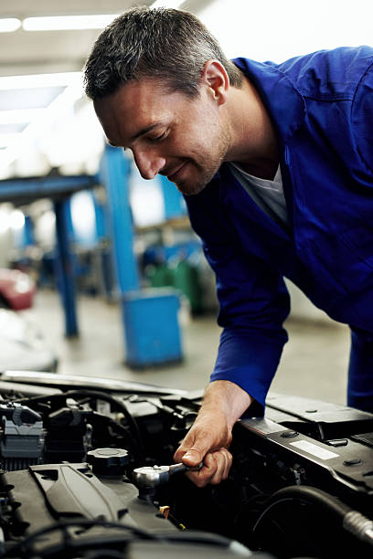 istock Mechanic tightening a new sparkplug into place 174982811