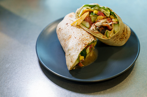 A close-up view of burritos served on a plate on a dining table