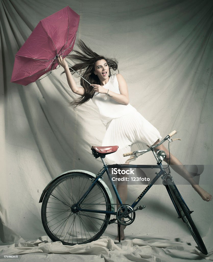 Women with umbrella. A young woman is fighting against the storm with her umbrella Adult Stock Photo