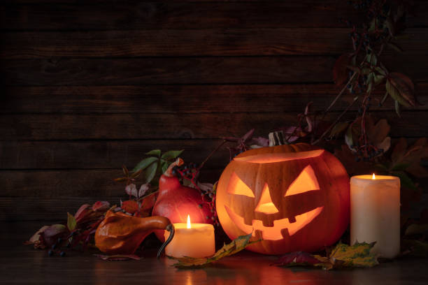 istock Halloween pumpkin head jack lantern with dried-up leaves. 1749840691