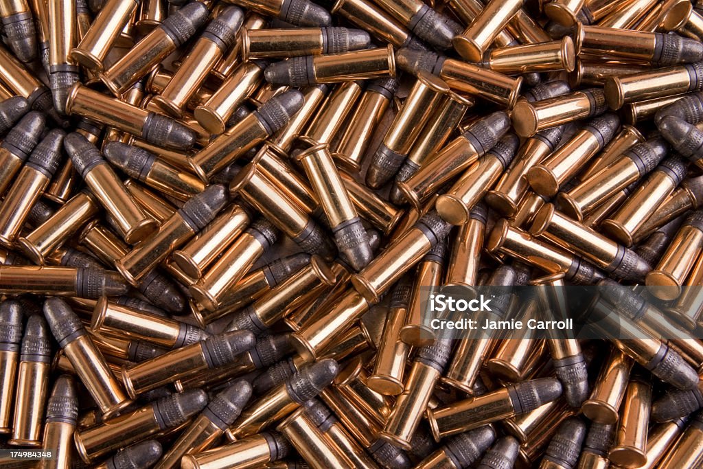 Pile of gold bulk 22 caliber ammo .22 caliber LR bulk ammo, round nose lead. Ammunition Stock Photo