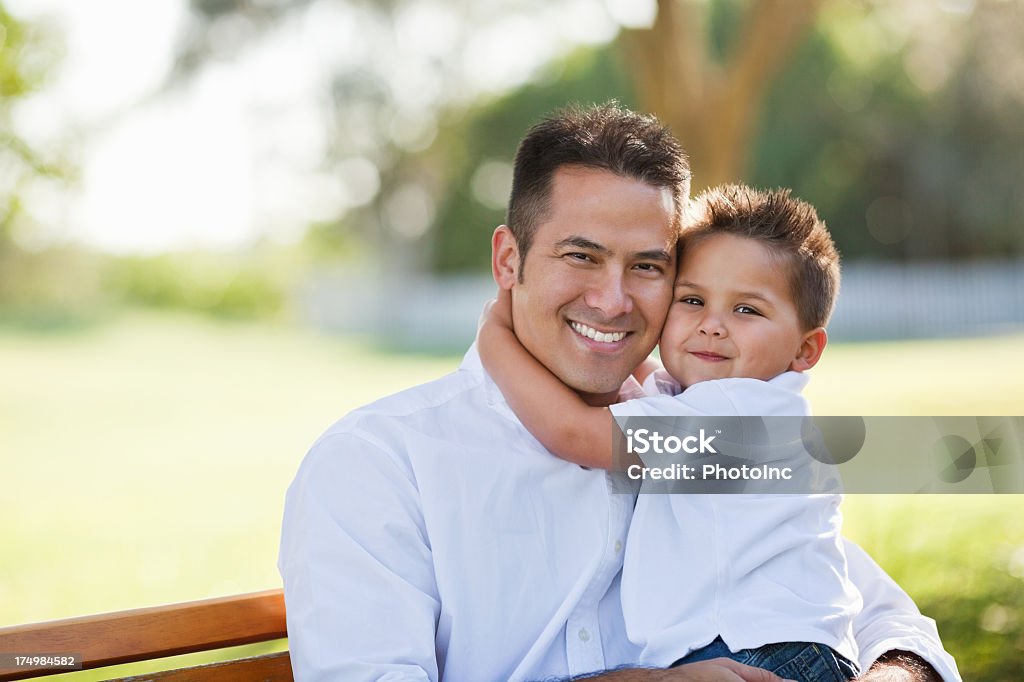 Menino abraçando o pai no parque - Foto de stock de Criança royalty-free