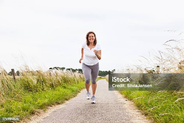 Mature Woman Fitness Sport Outdoors Stock Photo - Download Image Now - Overweight, Women, Jogging