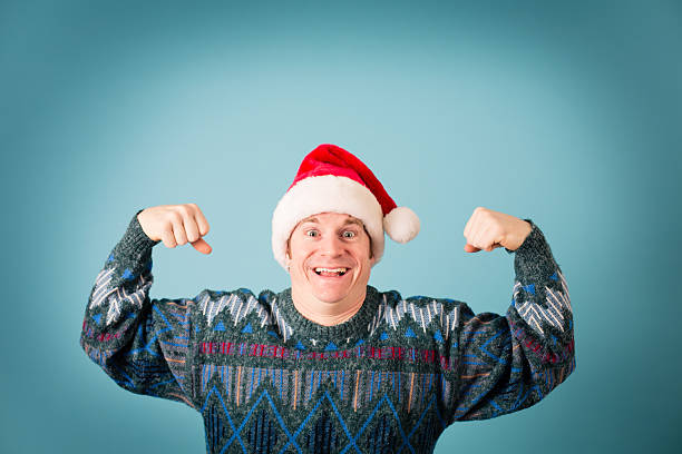 istock Man With Excited Look Wearing Santa Hat and Ugly Sweater 174984927