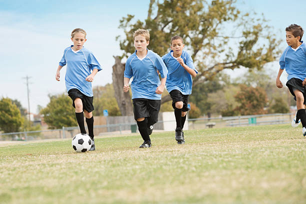 istock Kids team running during soccer game 174985184