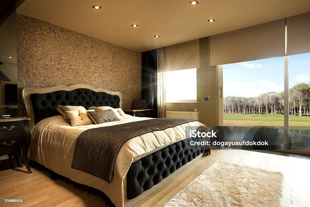 Luxury Bedroom Wide angle luxury hotel suite room and forest view. Domestic home bedroom with curtains and bed. Decoration image. Bedroom Stock Photo