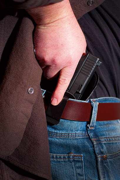 istock Concealed Carry Firearm Drawn From an Inside-the-Waistband Holster 174985927
