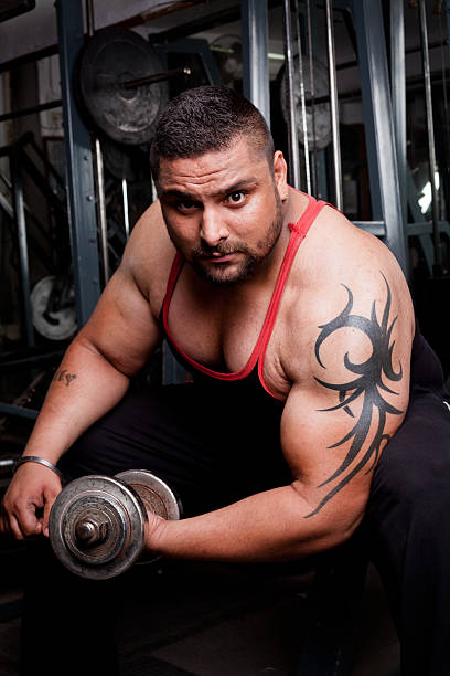 istock Strong Asian Indian Man Exercising in Gym 174986071