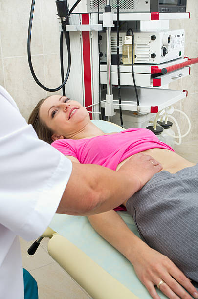 istock Doctor testing stomach of young woman 174986459