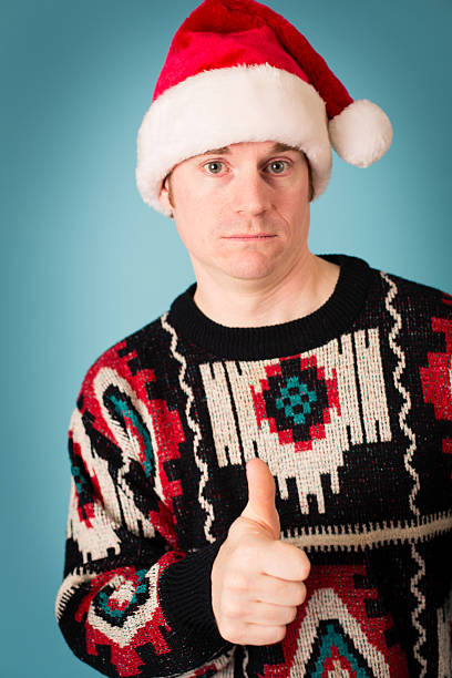istock Man Wearing Santa Hat and Ugly Sweater With Confidence 174986477