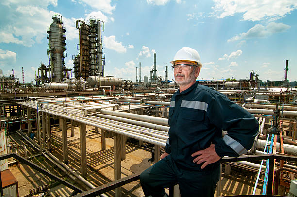 Engineer overseeing oil refinery stock photo
