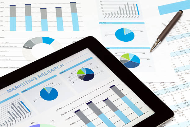 istock Tablet and papers with financial graphics and a pen 174986763