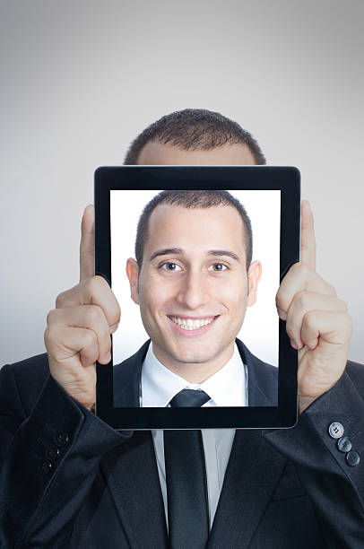 istock Young Businessman With His Face in a Digital Tablet 174987300
