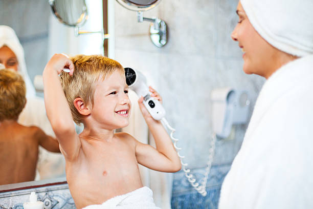 istock Little boy drying up hair after bath 174987658