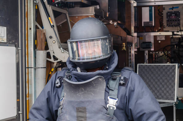 istock Man wearing bomb-proof suit and helmet as used by bomb squad ATOs while defusing bombs and mines 1749888366