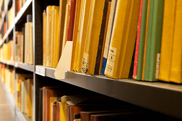 istock Close up of old books spines in a library shelf 174988855