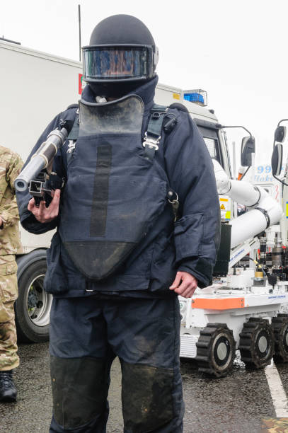 istock Man wearing bomb-proof suit and helmet as used by bomb squad ATOs while defusing bombs and mines 1749888800