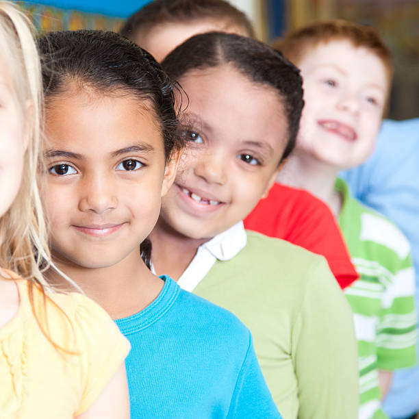 istock A few young children smiling in a line at school. 174988922