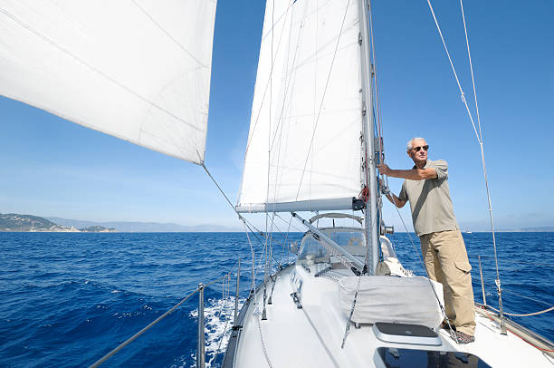 istock Senior man sailing through dark blue waters 174988972