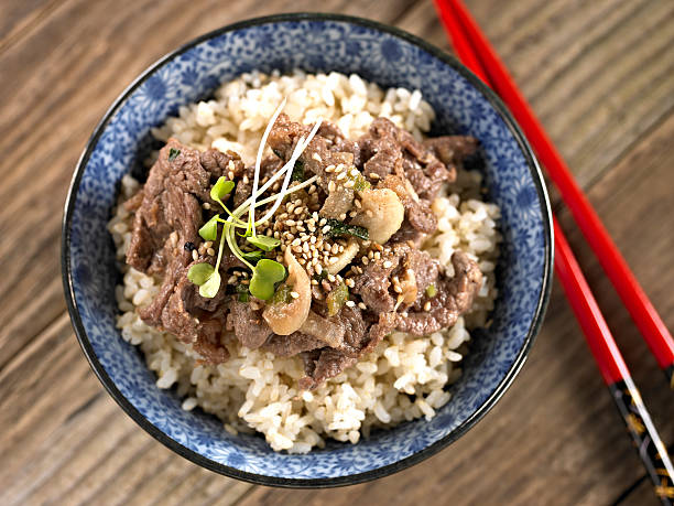 Bulgoki over Brown Rice. Bulgoki over Cooked Brown Rice. bulgoki stock pictures, royalty-free photos & images