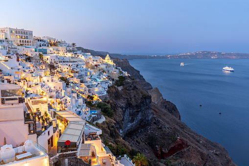 Panoramic view of the illuminated village Fira in the morning, Santorini, Greece