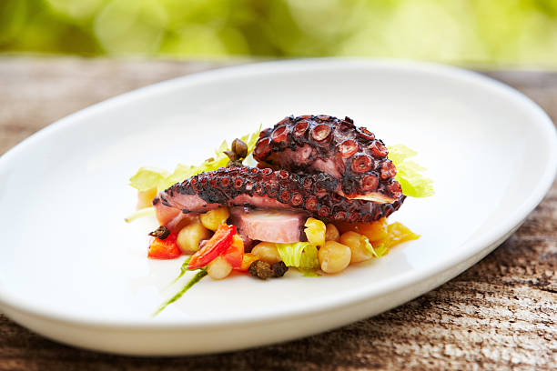 istock Grilled octopus with vegetables against nature background 174991688